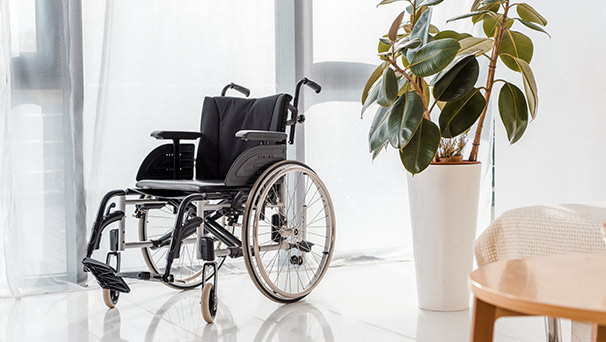 An empty wheelchair in a nursing home setting.